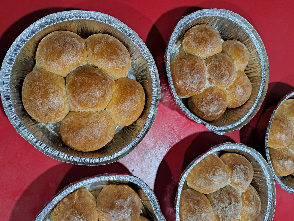 Trays of whole wheat rolls on a table