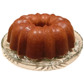 A navy bean bundt cake on a glass serving plate